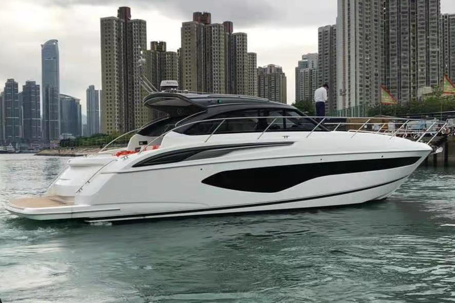 Princess V50 Open 2020 Princess V50 Open yacht docked near urban skyline.