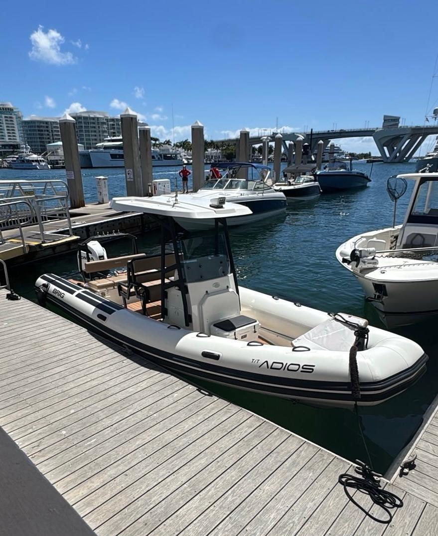 Brig Navigator 24 2022 Brig Navigator 24 boat docked at marina under clear blue sky.