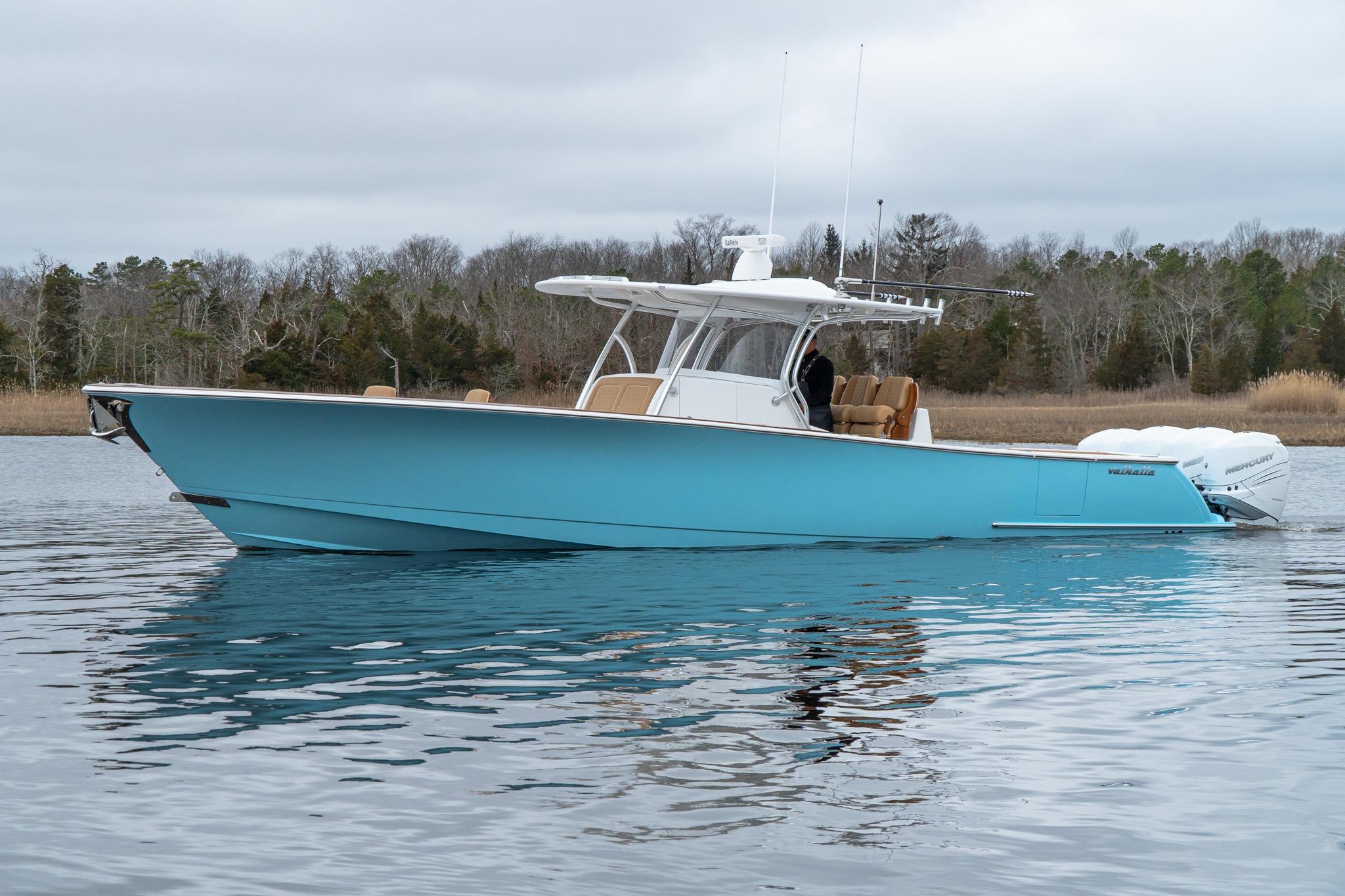 Valhalla Boatworks V-41 2026 Valhalla Boatworks V-41 in blue, cruising on calm water with wooded shoreline.