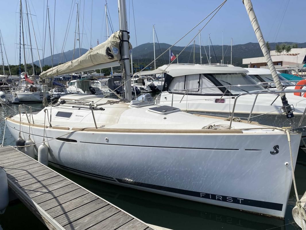 Beneteau First 25 2016 Beneteau First 25 sailboat docked in a marina, surrounded by other boats.