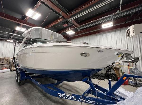 Regal LS9 Surf 2024 Regal LS9 Surf boat on trailer in indoor storage facility.
