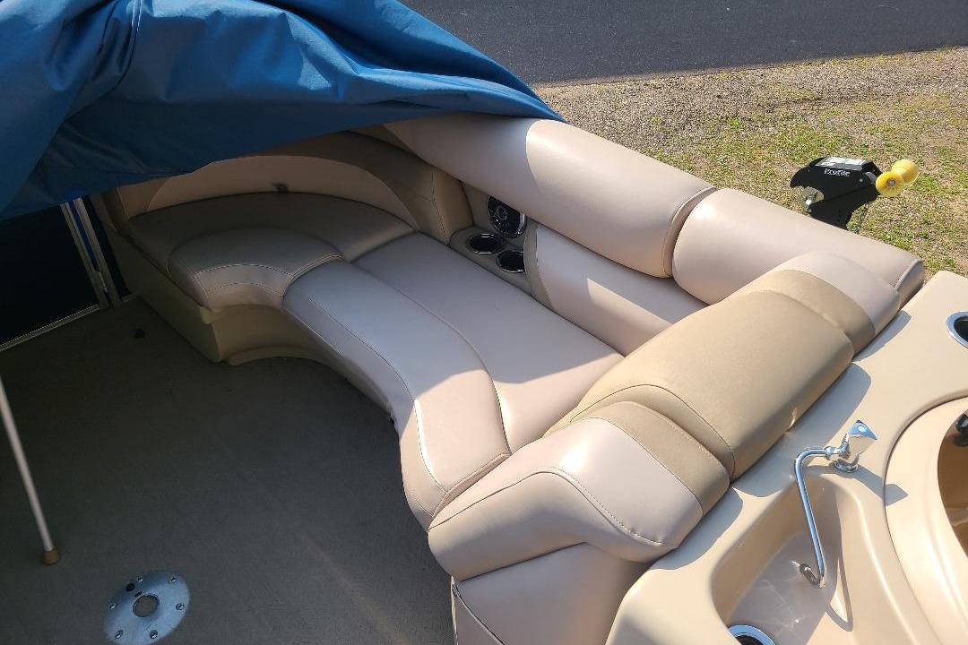Starcraft Limited 236 Starlounger Luxurious seating on 2013 Starcraft Limited 236 Starlounger boat, partially covered, with cup holders.