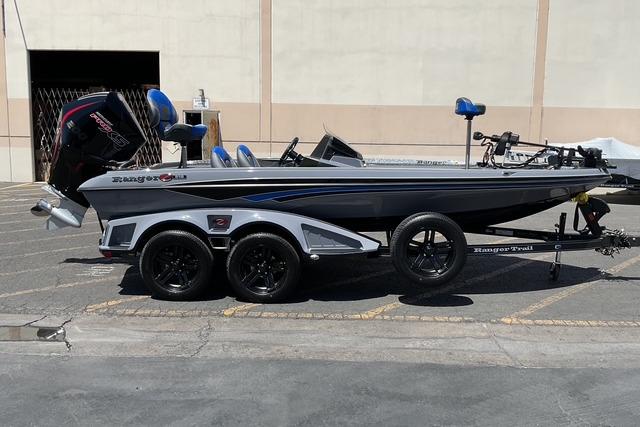 Ranger Z518 2026 Ranger Z518 fishing boat on trailer, parked outdoors, featuring sleek design and powerful engine.