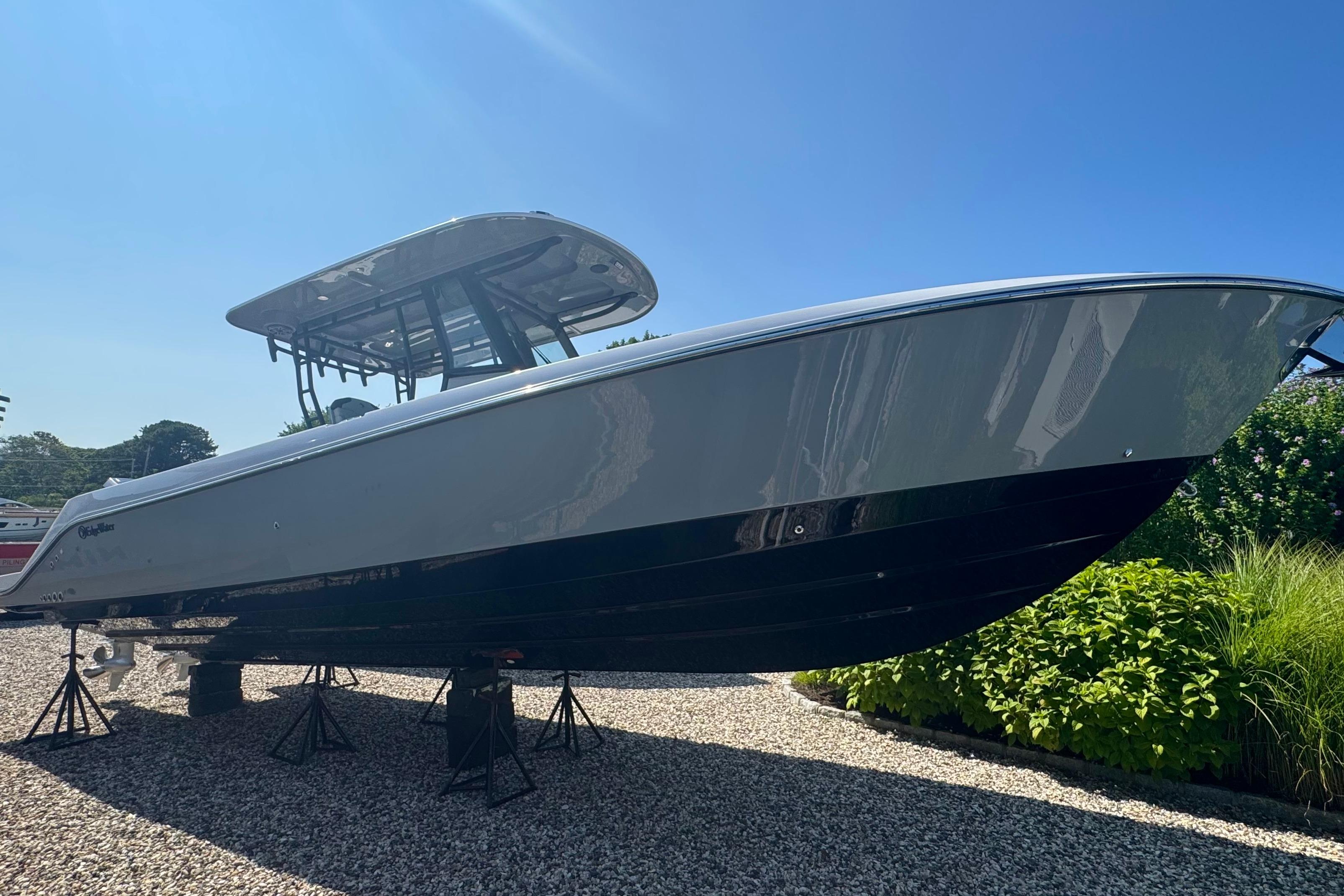 Edgewater 340CC 2025 Edgewater 340CC boat displayed outdoors on stands, under clear blue sky.