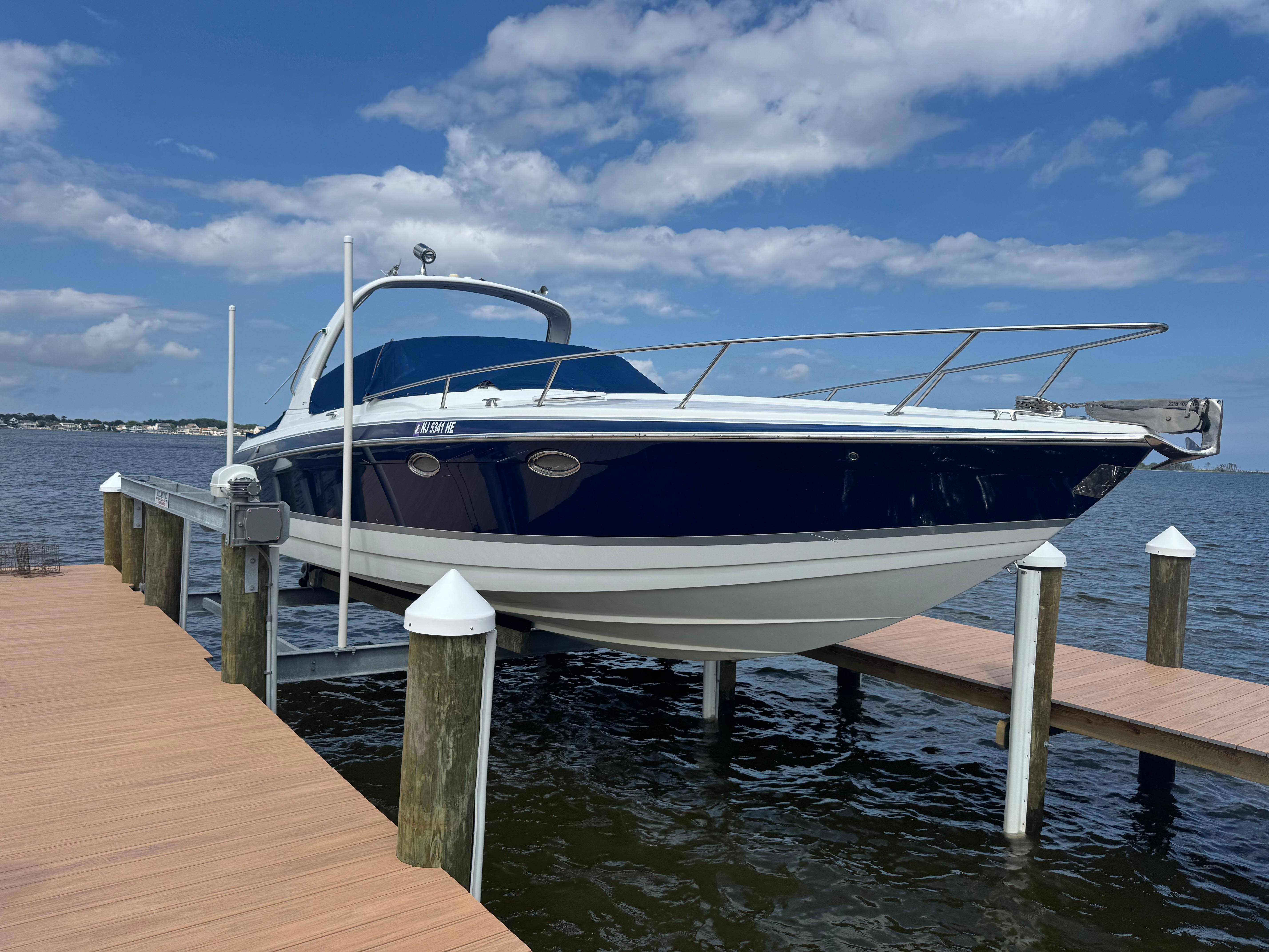 Formula 330 Sun Sport 2007 Formula 330 Sun Sport boat docked on a lift by the water.