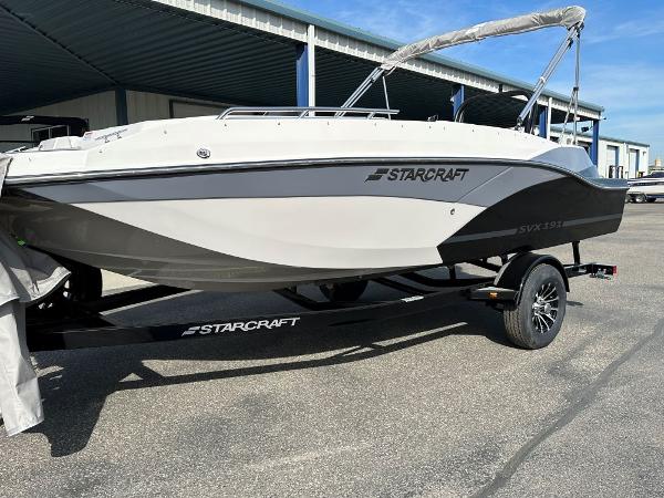 Starcraft SVX 191 OB 2024 Starcraft SVX 191 OB boat on a trailer in a parking lot.