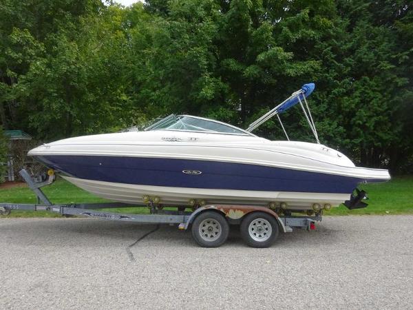 Sea Ray 220 Sundeck 2004 Sea Ray 220 Sundeck boat on trailer, parked on a road.