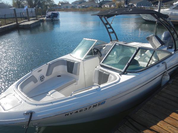 Chaparral 21 SSi OB 2022 Chaparral 21 SSi OB boat docked on calm water.