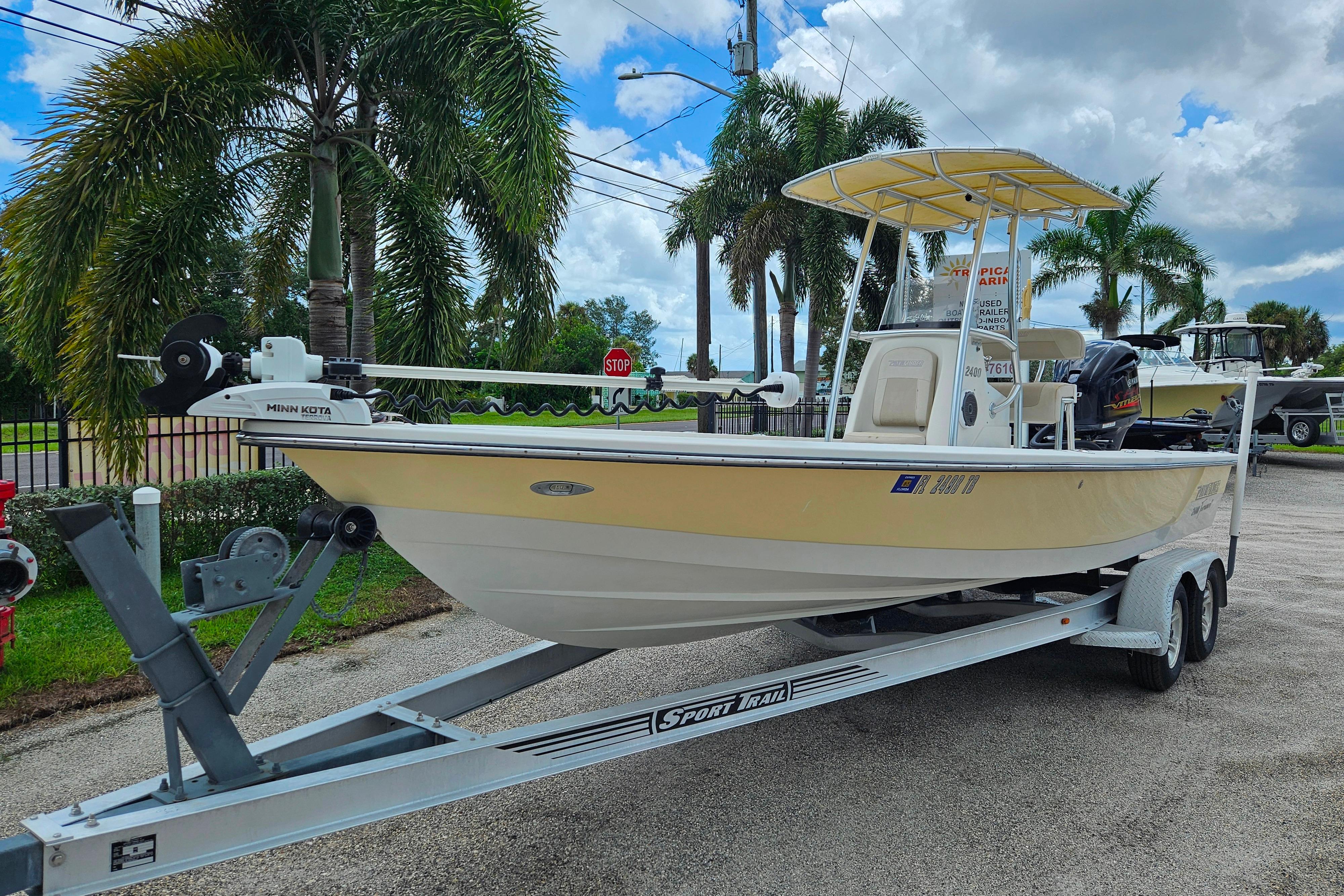 Pathfinder 2400 Tournament adition engine 2022 2011 Pathfinder 2400 Tournament Edition boat on trailer, parked near palm trees.