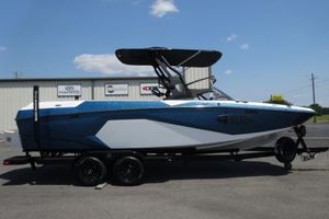 Axis A245 2025 Axis A245 boat on trailer, blue and white design, parked outdoors.