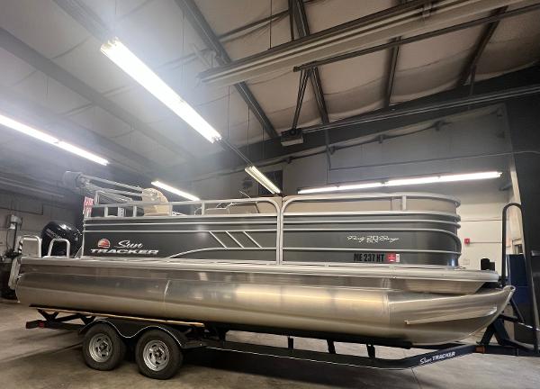 Sun Tracker Party Barge 20 DLX 2020 Sun Tracker Party Barge 20 DLX pontoon boat on trailer in indoor storage.