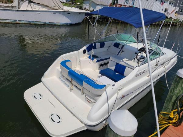 Sea Ray 240 Sundancer 1996 Sea Ray 240 Sundancer boat docked, featuring blue and white seating and a canopy.