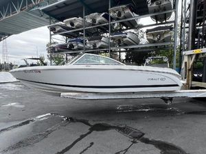 Cobalt 220 2015 Cobalt 220 boat on a lift in a marina storage area.