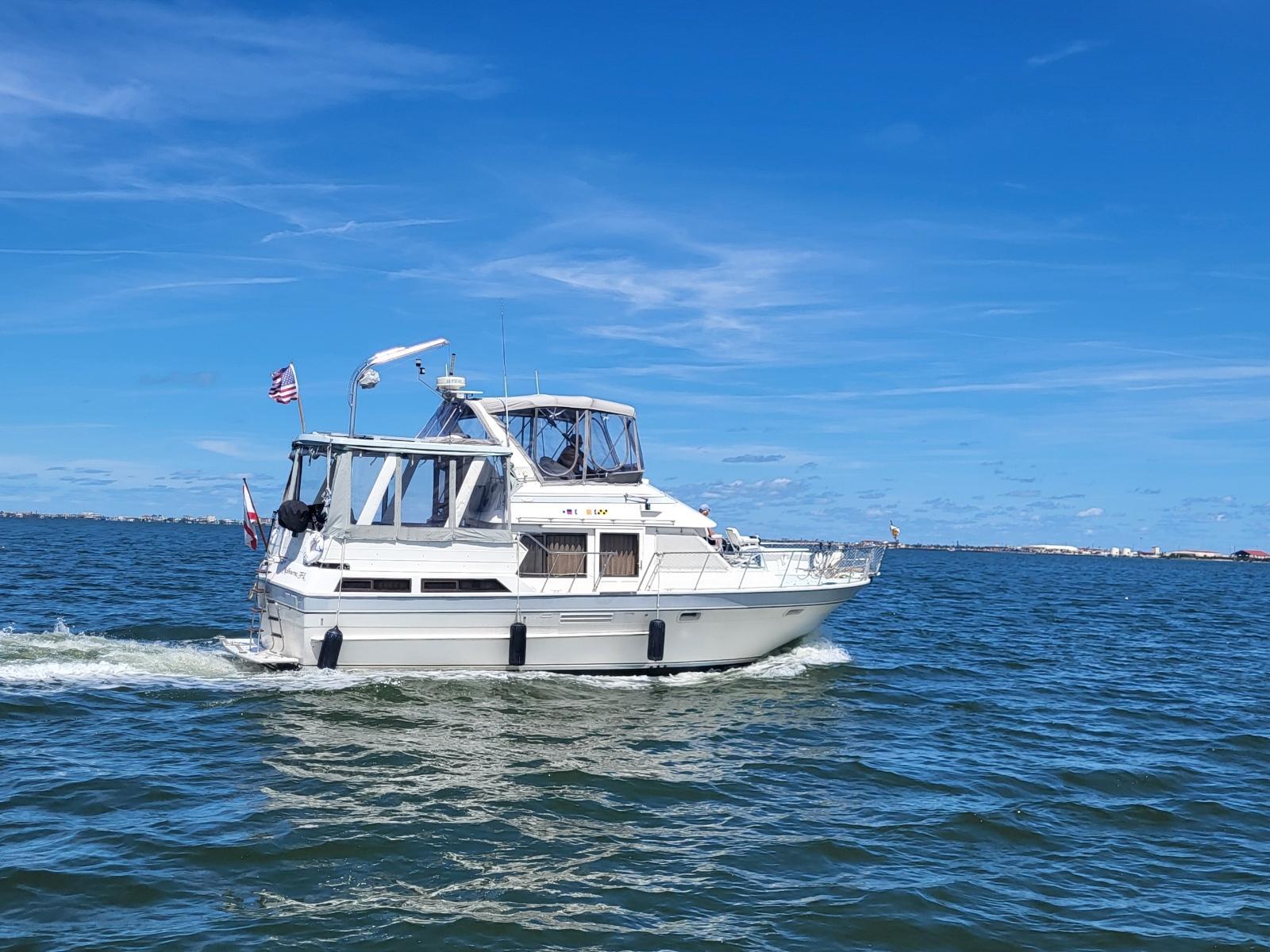 Kha Shing 38 1987 Kha Shing 38 yacht cruising on open water under clear blue skies.