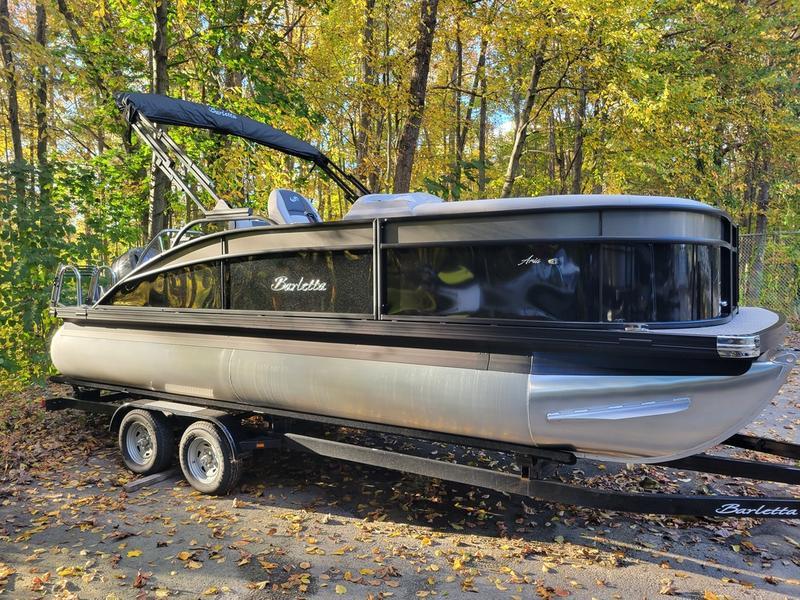 Barletta A20UC 2025 Barletta A20UC pontoon boat on trailer, surrounded by autumn trees.