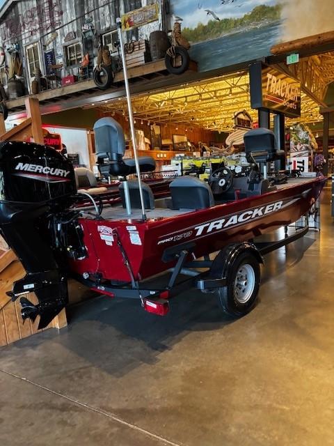 Tracker Pro 170 2025 Tracker Pro 170 boat with Mercury engine displayed indoors.