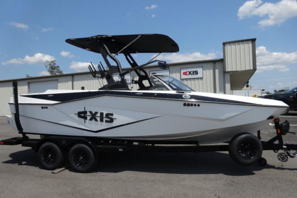 Axis T220 2024 Axis T220 boat on trailer, parked outside dealership under blue sky.
