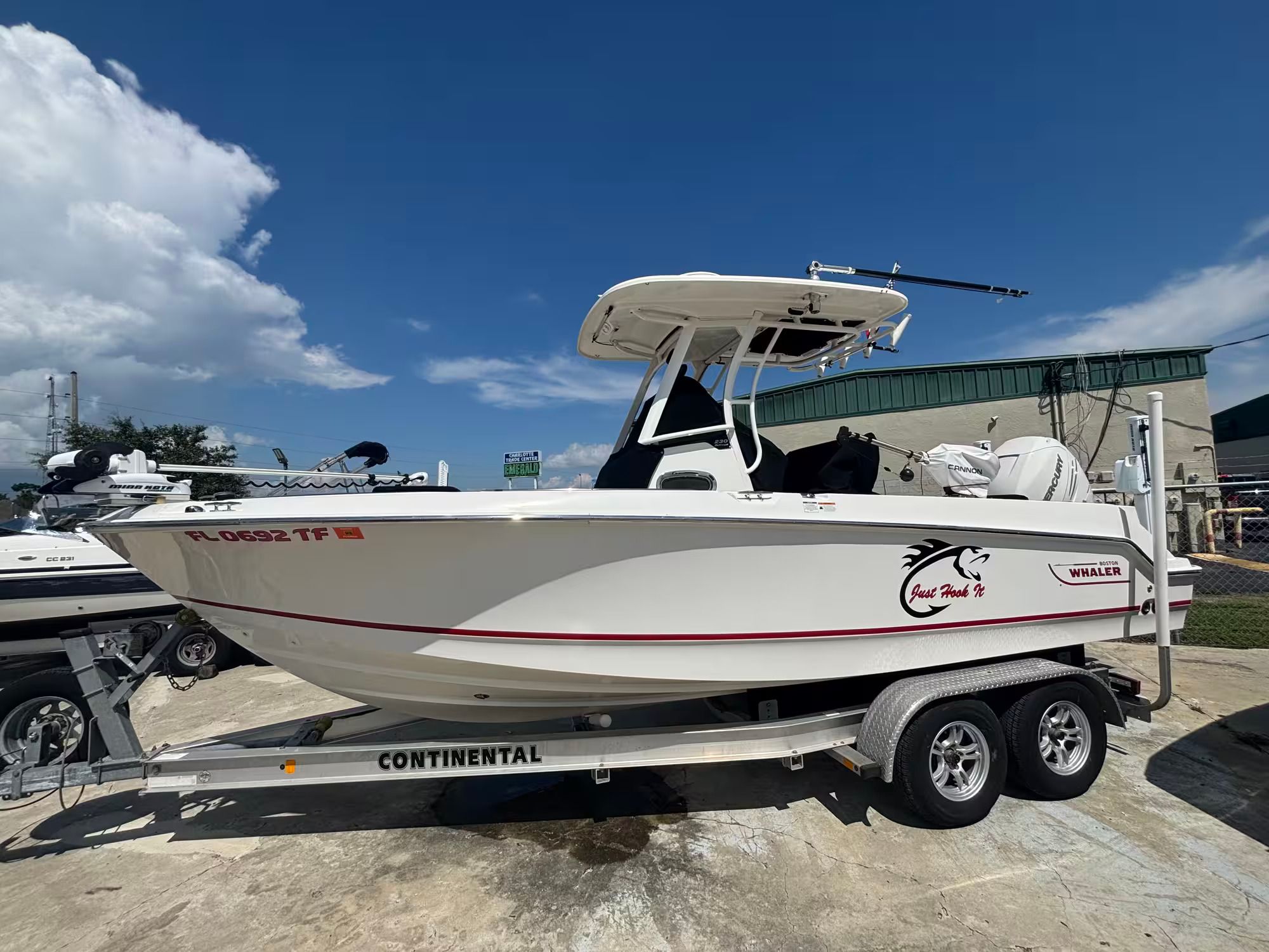 Boston Whaler 230 Outrage 2017 Boston Whaler 230 Outrage boat on trailer under clear blue sky.