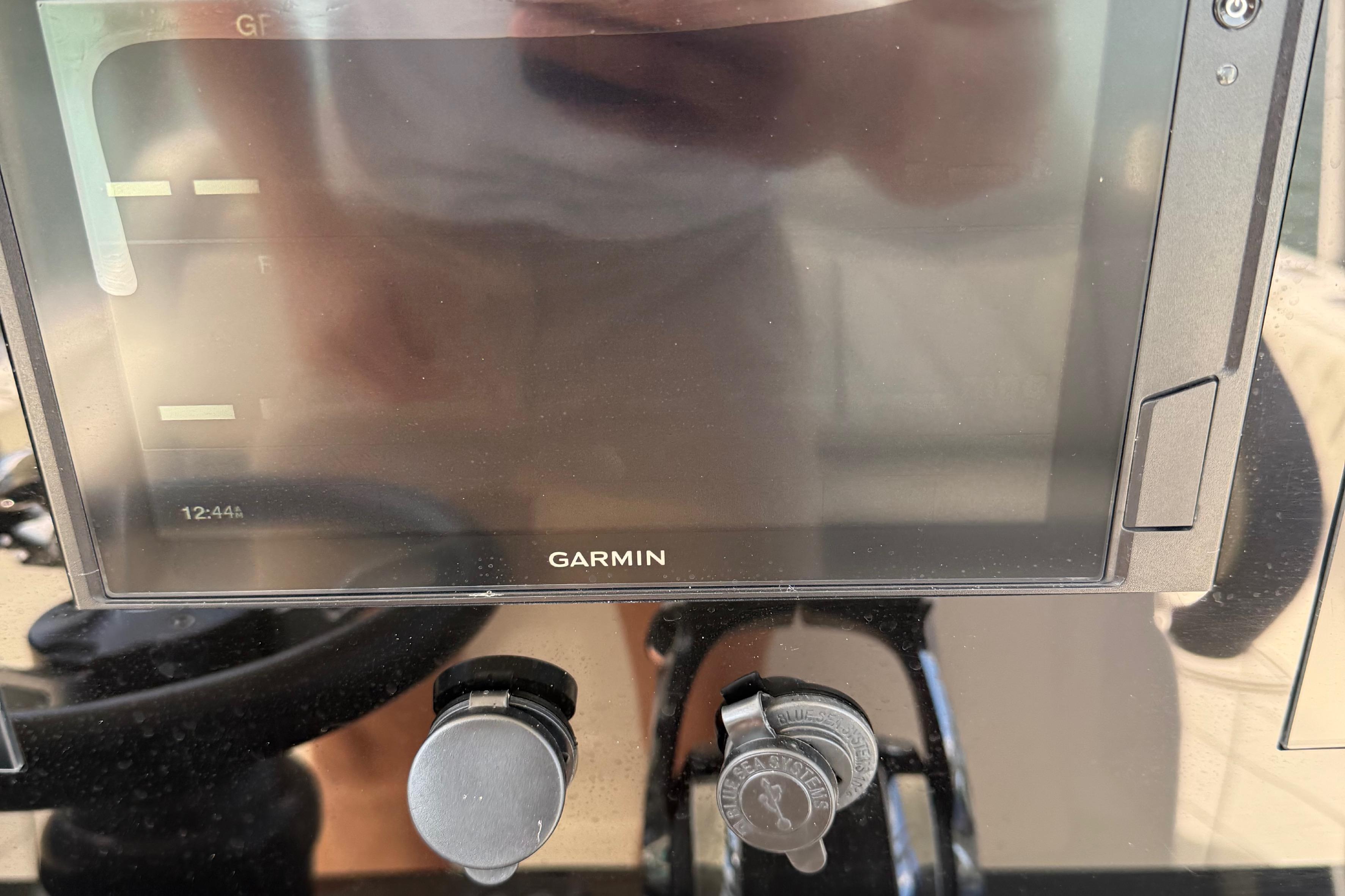 Marlago Cuddy Marlago 35 Garmin display on 2005 Marlago 35 boat dashboard with control knobs.