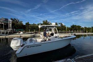 Sportsman Open 242 Center Console 2021 Sportsman Open 242 Center Console boat docked, featuring Yamaha engine, under clear blue sky.