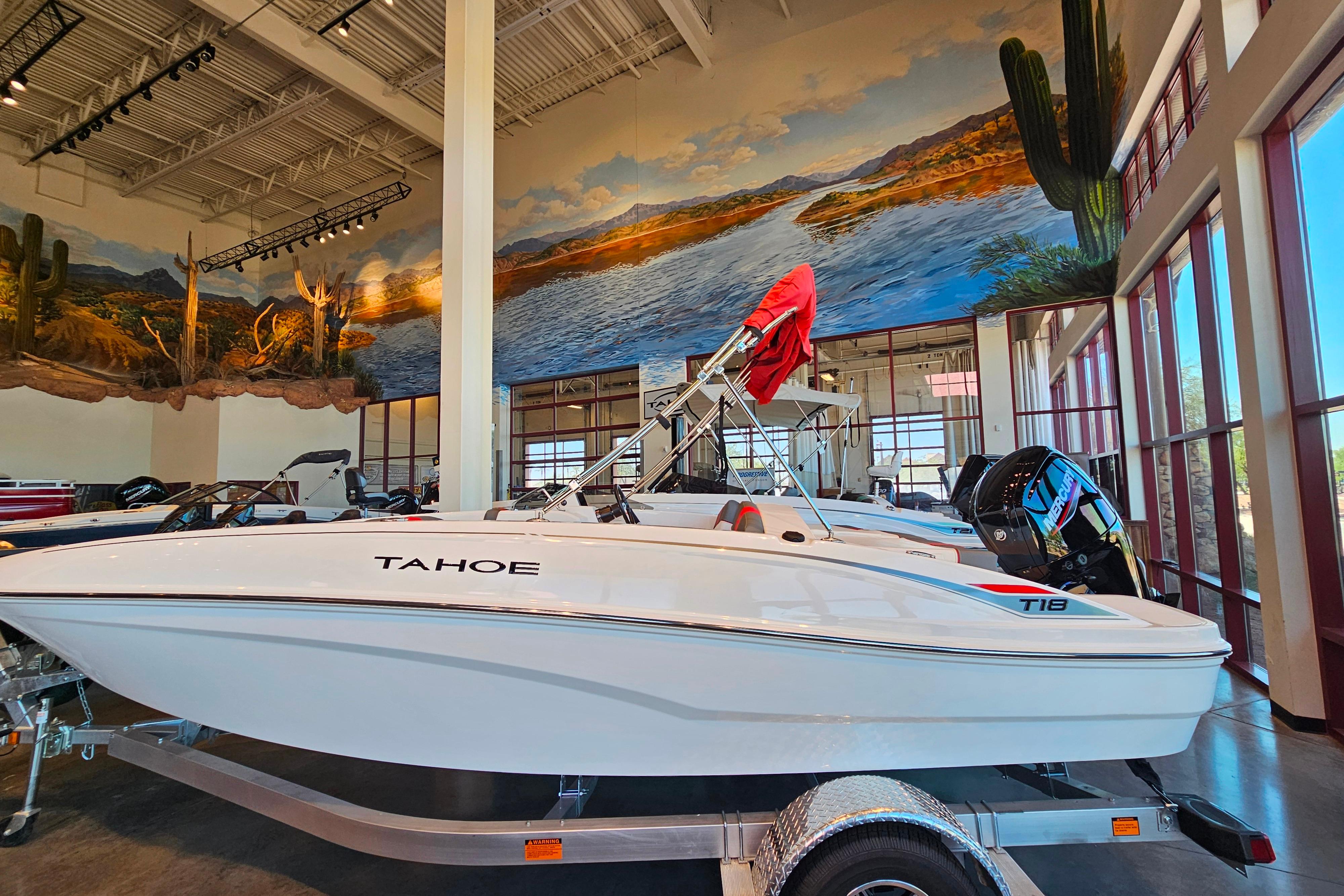 Tahoe T18 2025 Tahoe T18 boat displayed indoors with scenic mural background.