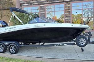 Tahoe 200 S 2025 Tahoe 200 S boat on trailer, parked outdoors near a building.