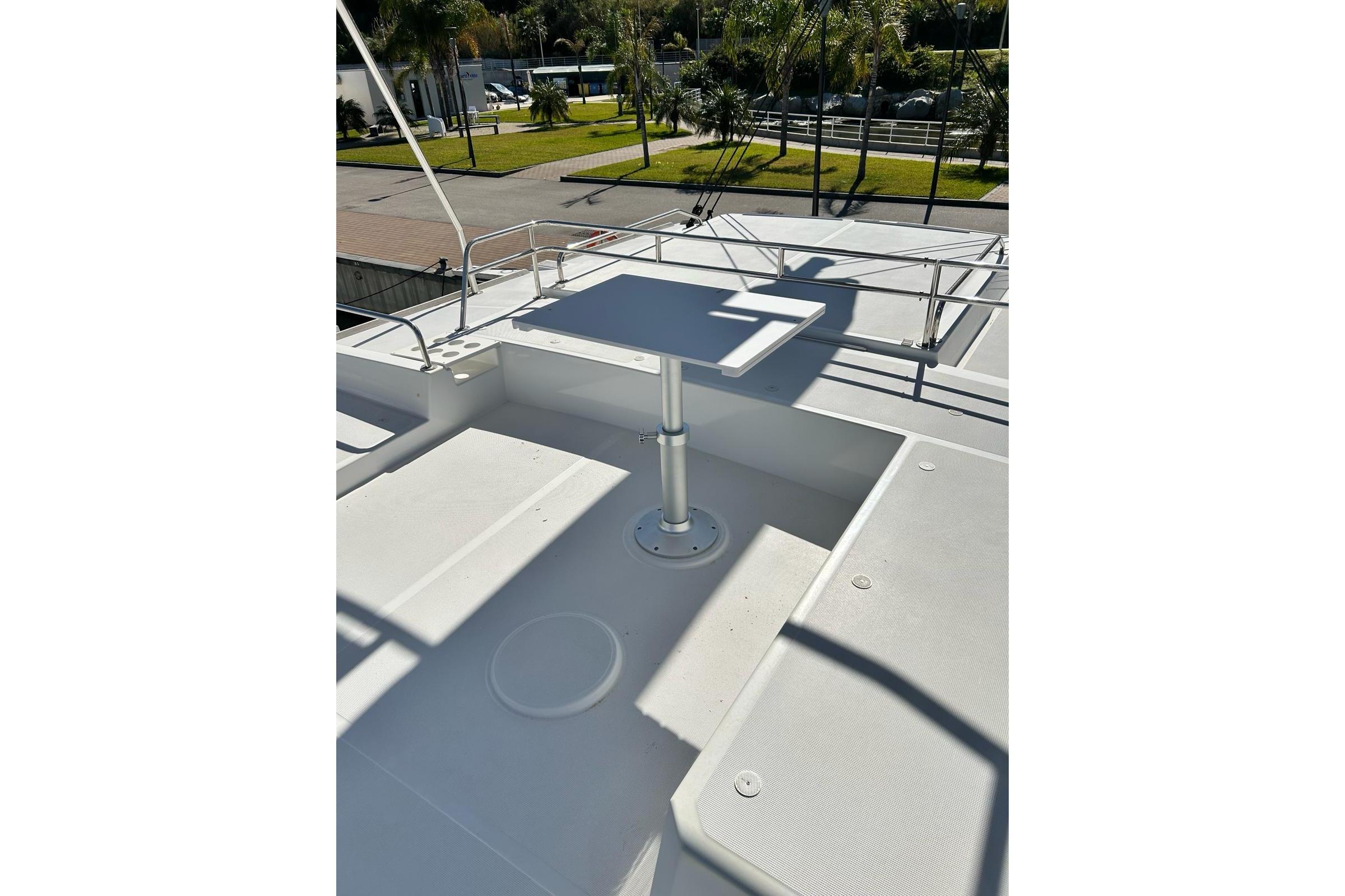 Bali Bali 4.8 Rooftop deck of 2020 Bali 4.8 catamaran with seating and table.