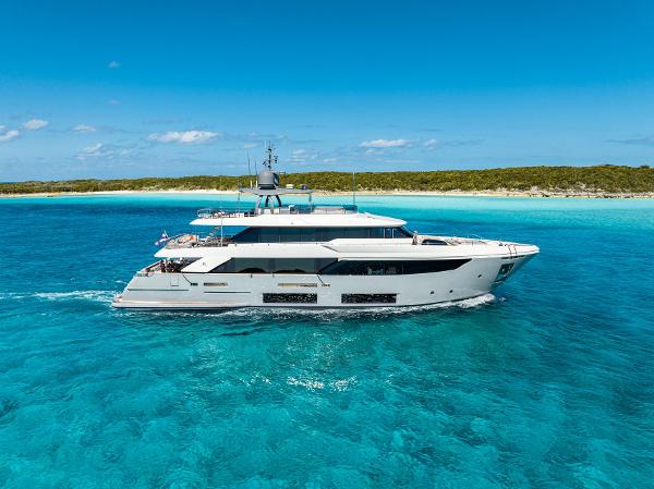 Custom Line Navetta 33 Luxurious 2018 Custom Line Navetta 33 yacht cruising in clear turquoise waters.