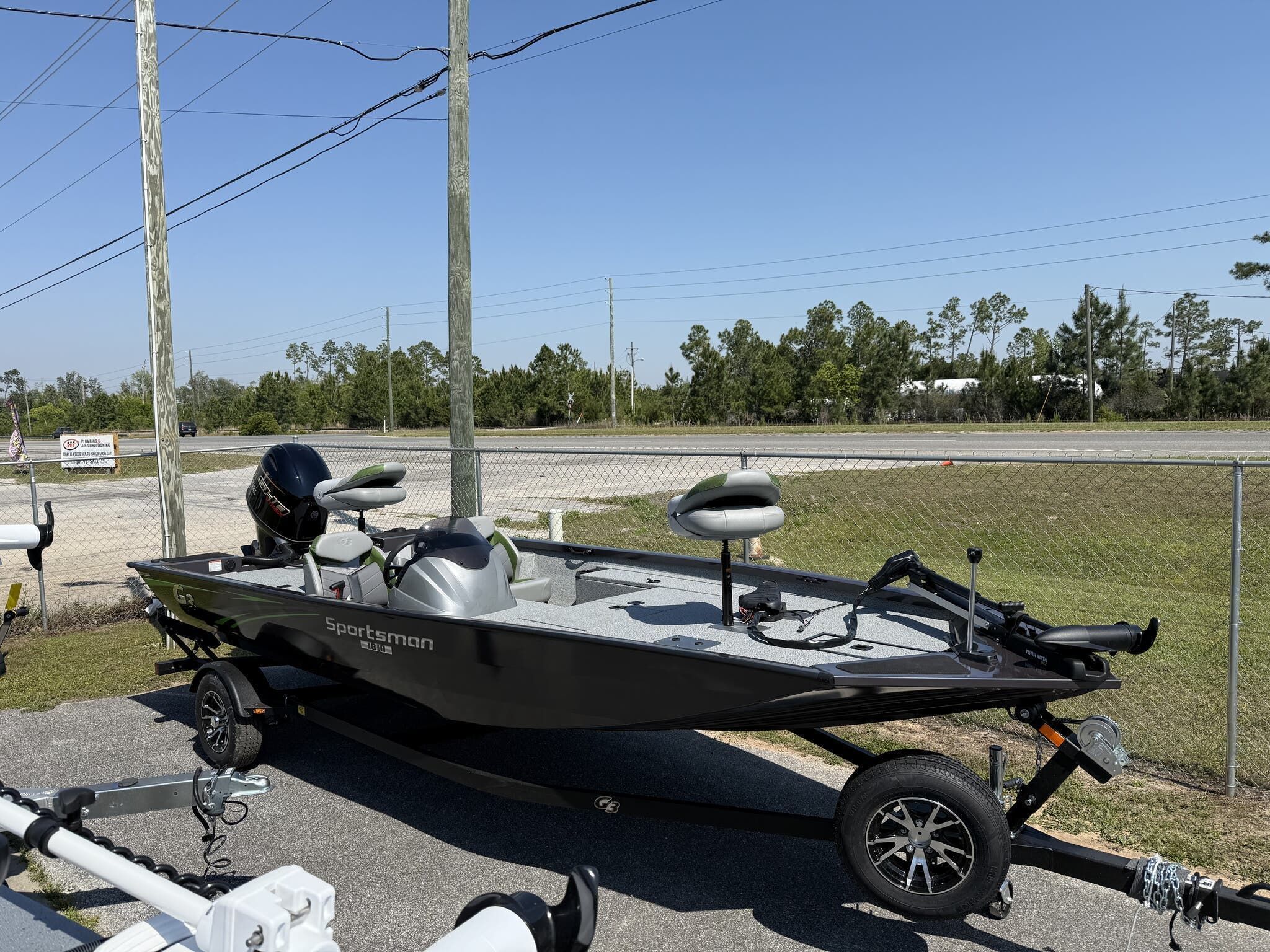 G3 Sportsman 1810 2025 G3 Sportsman 1810 boat on trailer, parked outdoors under clear sky.