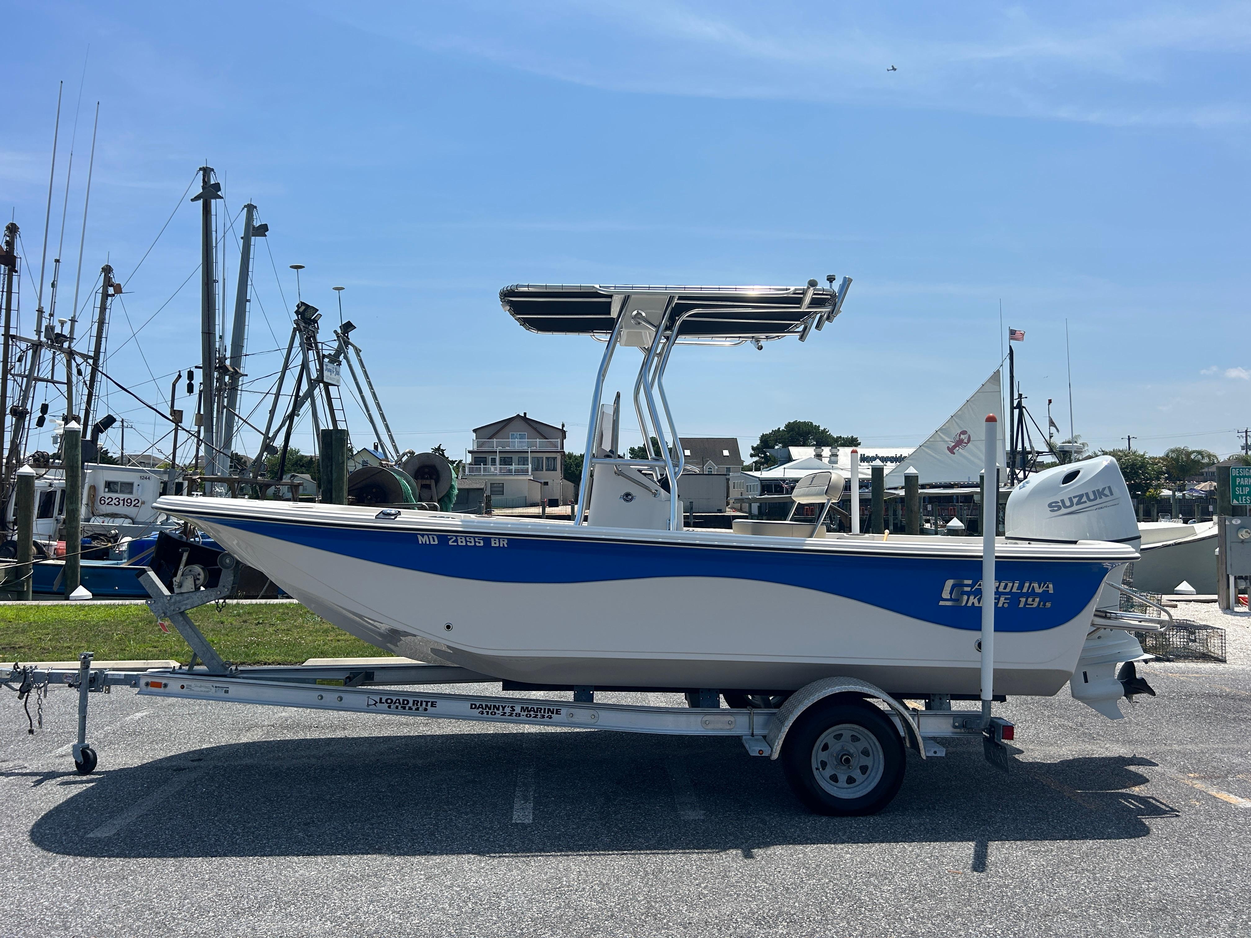 Carolina Skiff 19 LS 2022 Carolina Skiff 19 LS boat on trailer, dockside with clear blue sky.