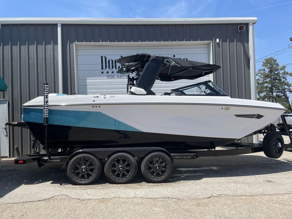 Nautique Super Air Nautique G23 2023 Nautique Super Air Nautique G23 boat on trailer, parked outside a building.