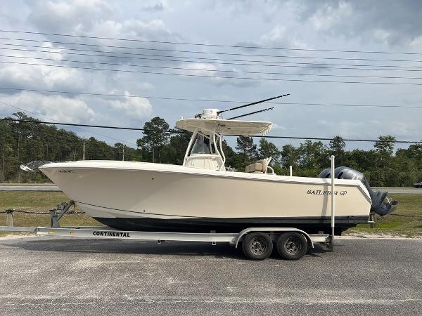 Sailfish 270 CC 2017 Sailfish 270 CC boat on trailer, parked outdoors under cloudy sky.