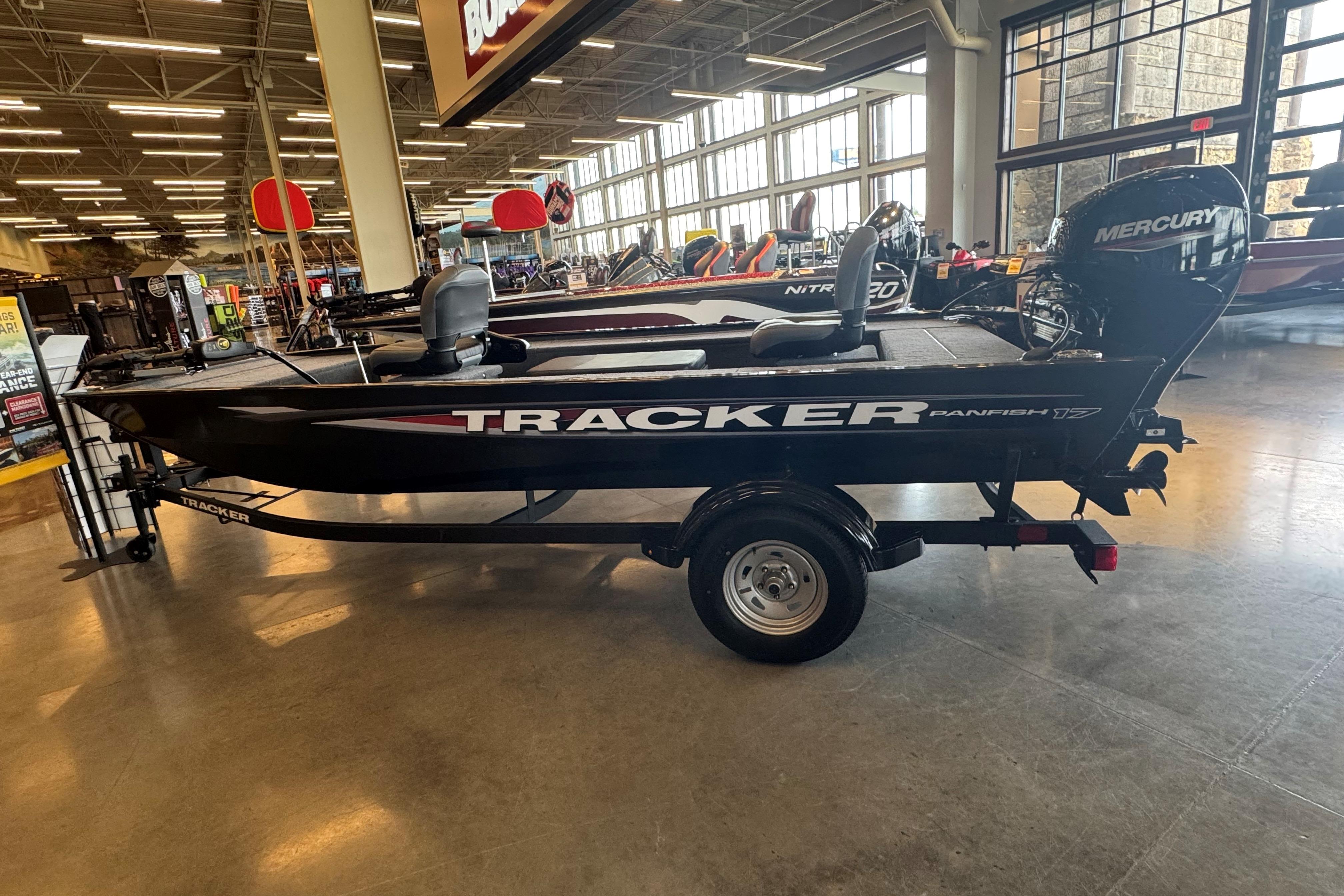 Tracker Panfish 17 2025 Tracker Panfish 17 boat displayed indoors with Mercury engine.