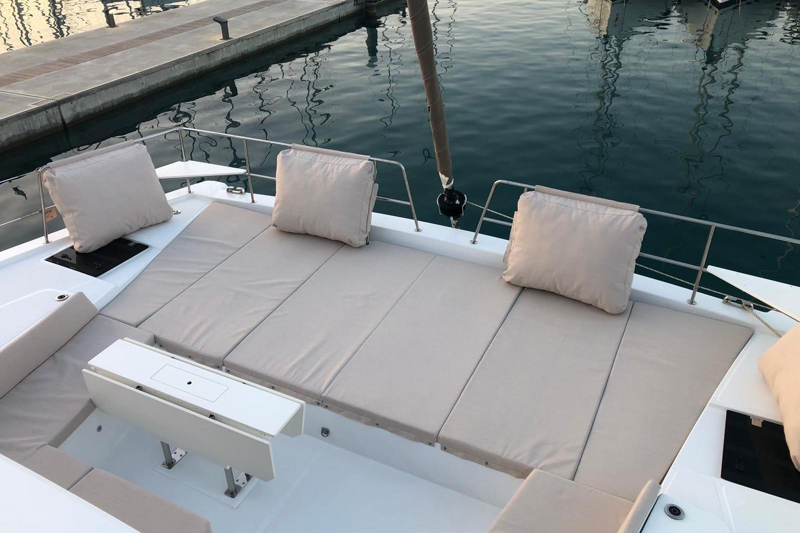 Bali Bali 4.8 Luxurious seating area on a 2021 Bali 4.8 catamaran, docked by the water.