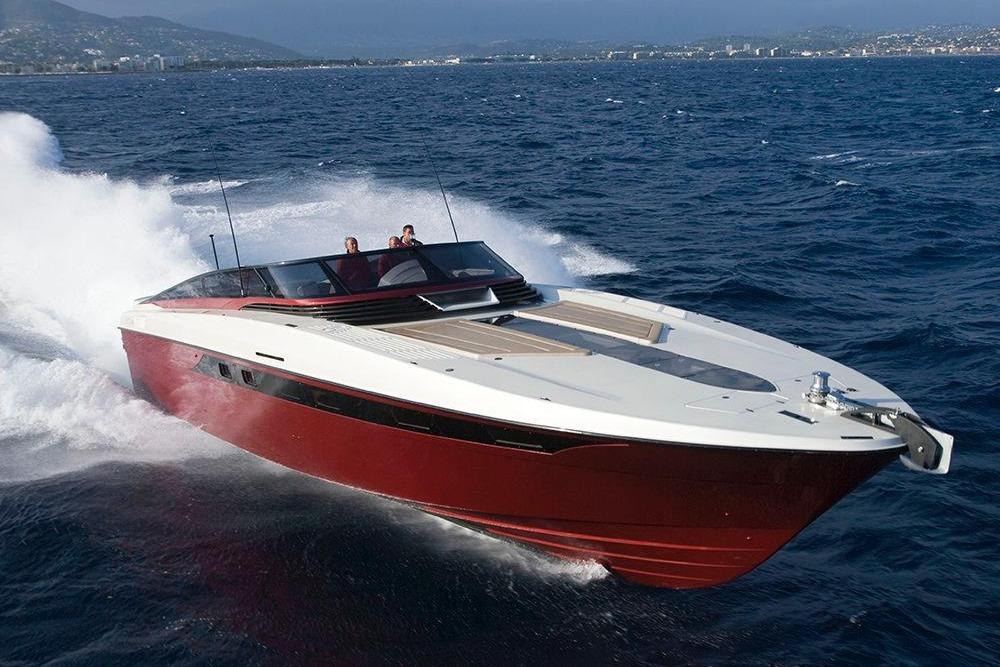 Otam 58 Millennium Open 2010 Otam 58 Millennium Open yacht cruising on the ocean with scenic coastline backdrop.