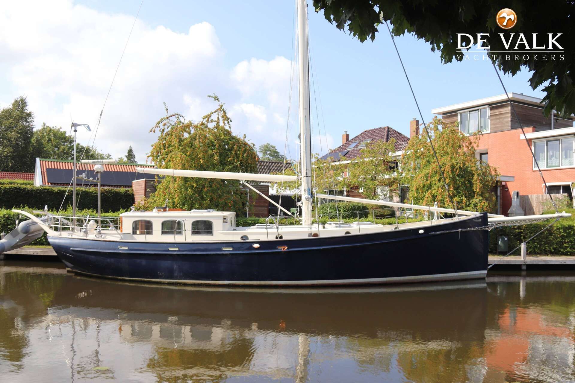 Puffin 50 Sailing yacht Puffin 50, 1999 model, docked in a serene residential canal.