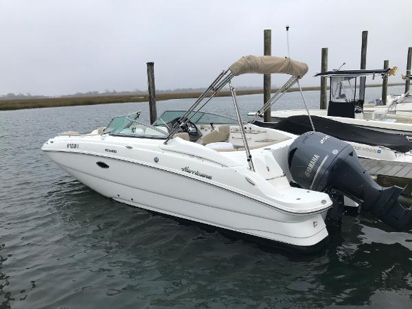 Hurricane SD2400 2017 Hurricane SD2400 boat docked, featuring Yamaha outboard motor and beige canopy.