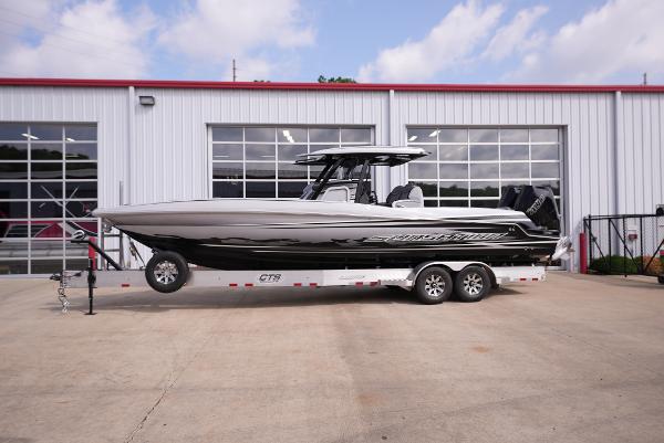 Sunsation 32CCX 2024 Sunsation 32CCX boat on a trailer outside a garage.