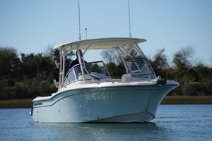 Grady-White Freedom 235 2022 Grady-White Freedom 235 boat cruising on calm water with trees in the background.