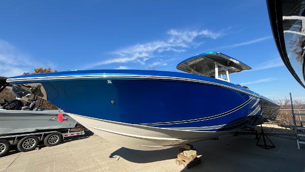 Fountain 34 SC 2021 Fountain 34 SC boat with sleek blue hull on display outdoors.