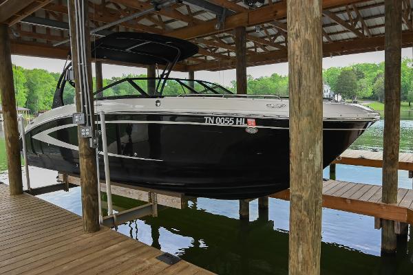 Sea Ray 270 Sundeck 2016 Sea Ray 270 Sundeck boat docked under a wooden shelter.