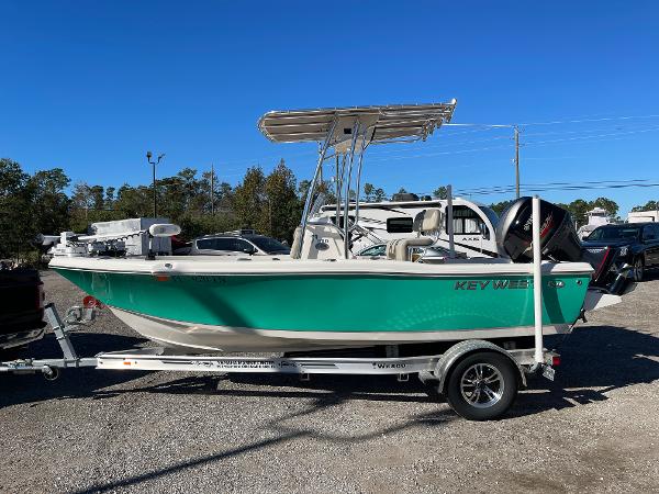 Key West 179 FS 2023 Key West 179 FS boat on trailer, green hull, parked outdoors.