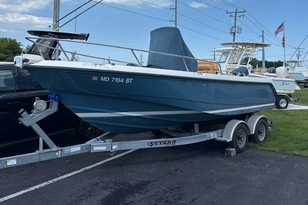 Boston Whaler 210 Outrage 2004 Boston Whaler 210 Outrage boat on trailer, parked outdoors.