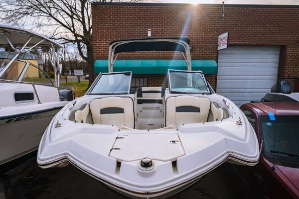 Chaparral 224 Sunesta 2018 Chaparral 224 Sunesta boat with open bow seating, parked near a brick building.