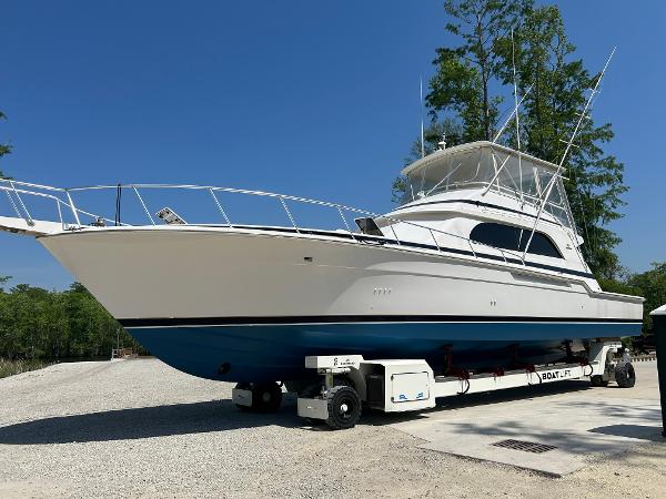 Bertram 60 Convertible 1999 Bertram 60 Convertible yacht on a trailer in a boatyard.