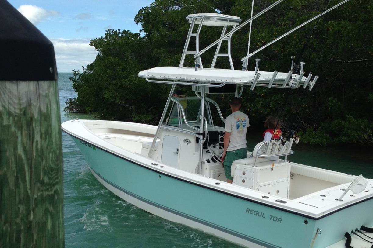 Regulator 26 Forward Seating 2003 Regulator 26 Forward Seating boat navigating through a narrow waterway.