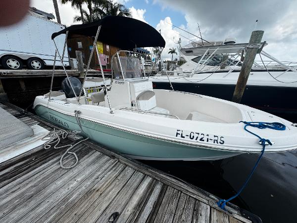 Robalo R180 Center Console 2018 Robalo R180 Center Console boat docked at marina with canopy and registration number visible.