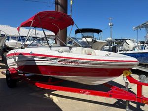 Tahoe Q5i 2011 Tracker Tahoe Q5i boat with red and white design, parked on a trailer.