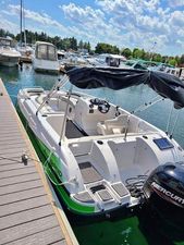 Legend D19 2022 Legend D19 boat docked at marina, featuring a Mercury outboard motor.