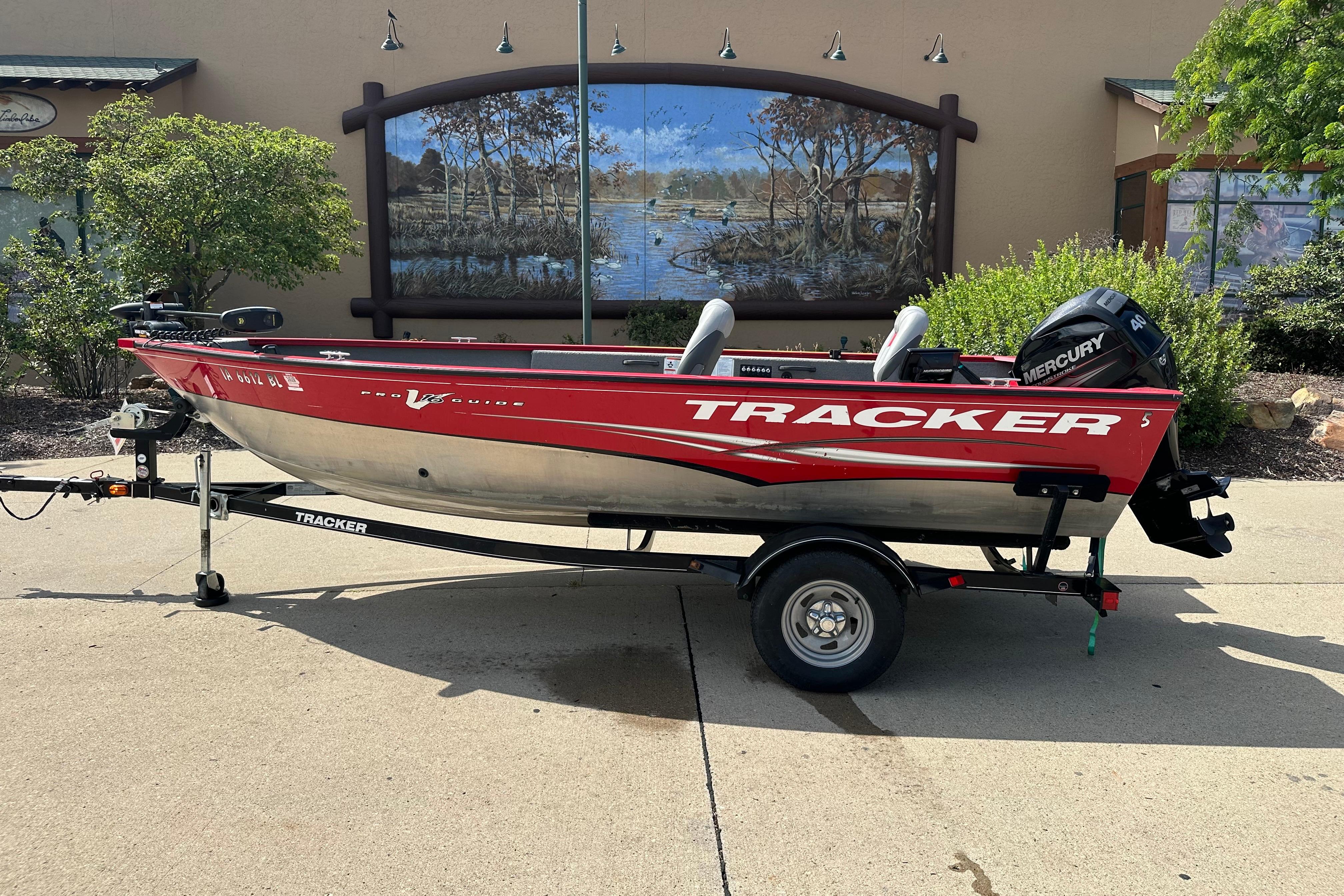 Tracker Pro Guide V 16 T 2013 Tracker Pro Guide V 16 T boat on trailer, red and silver design.